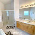 Large master bathroom with two sinks and a wide shower stall at Sunshine Villa at Glenbrook Resort, a short-term vacation rental home in Orlando near Walt Disney World